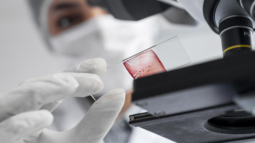 close-up-blurry-scientist-working-with-glass-slide.jpg